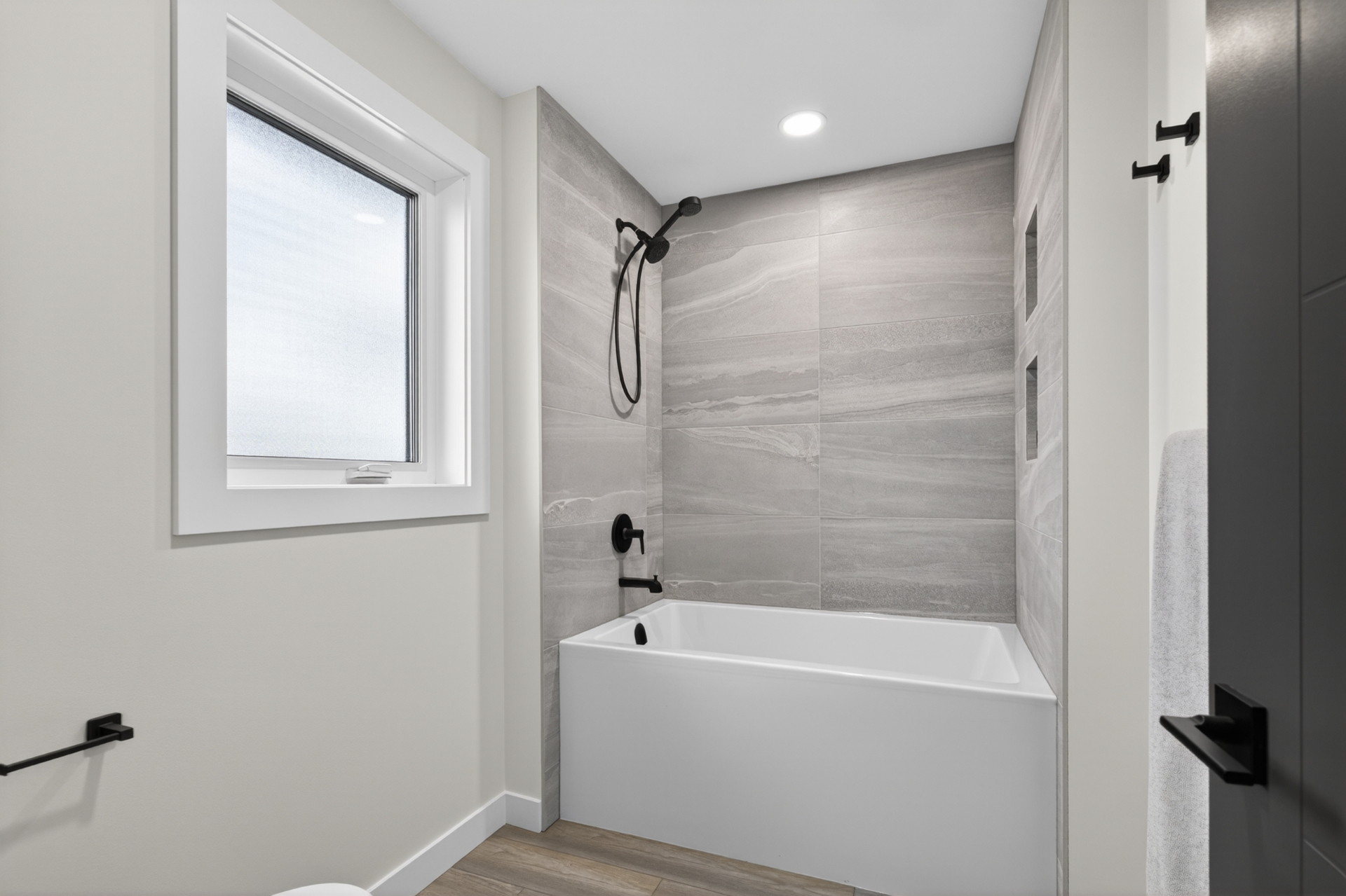 Jack & Jill — Bath — A deep tub with porcelain tile surround