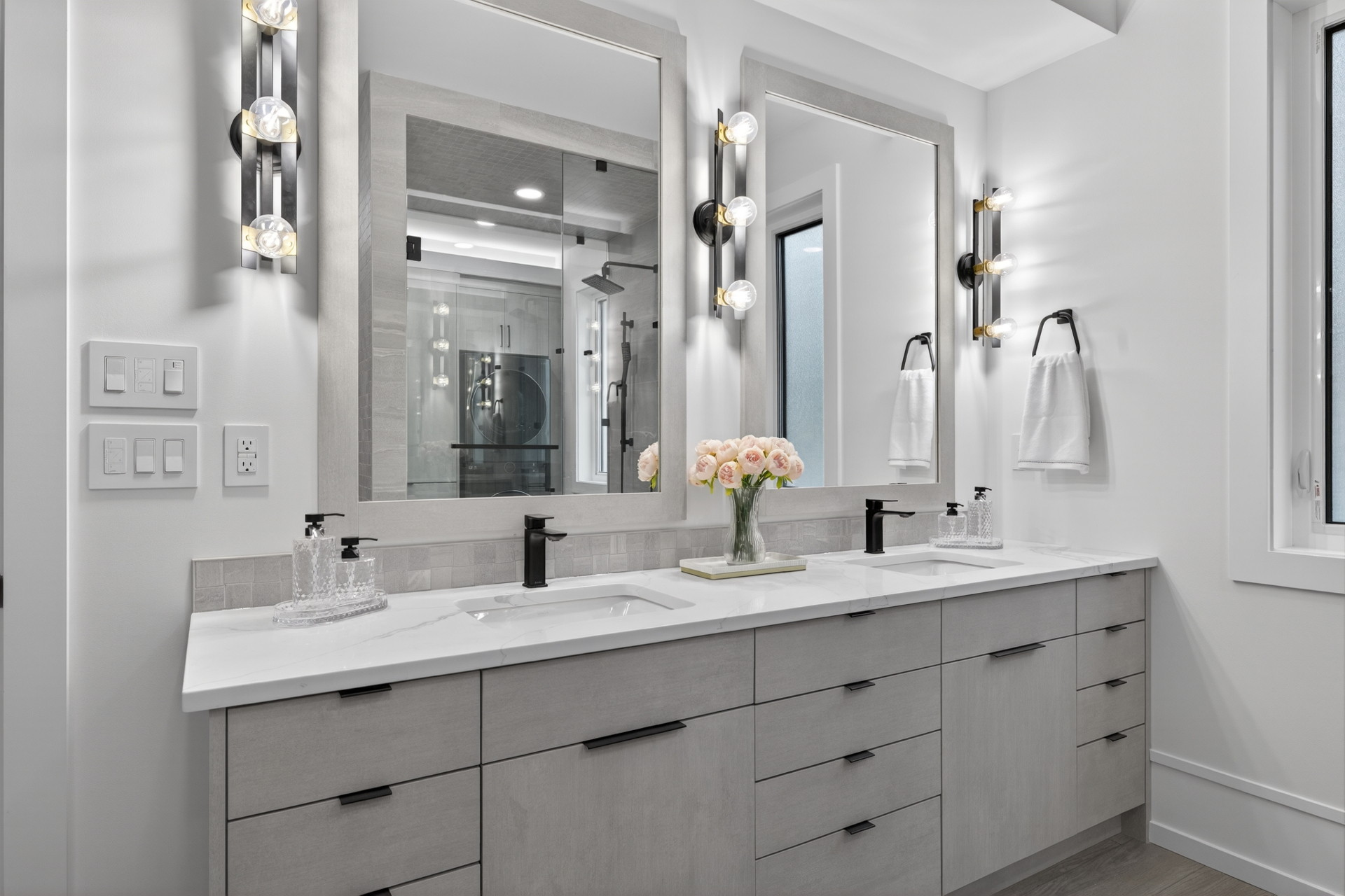 Main-floor ensuite with a double vanity, quartz counters and matte black fixtures